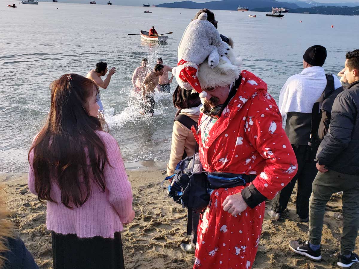 Man in a red robe with polar bear hat at Polar Bear Swim Vancouver.