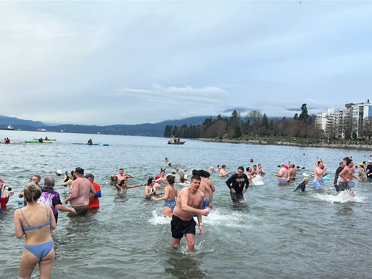 Swimmers Splashing into the Water at Polar Bear Swim Vancouver.