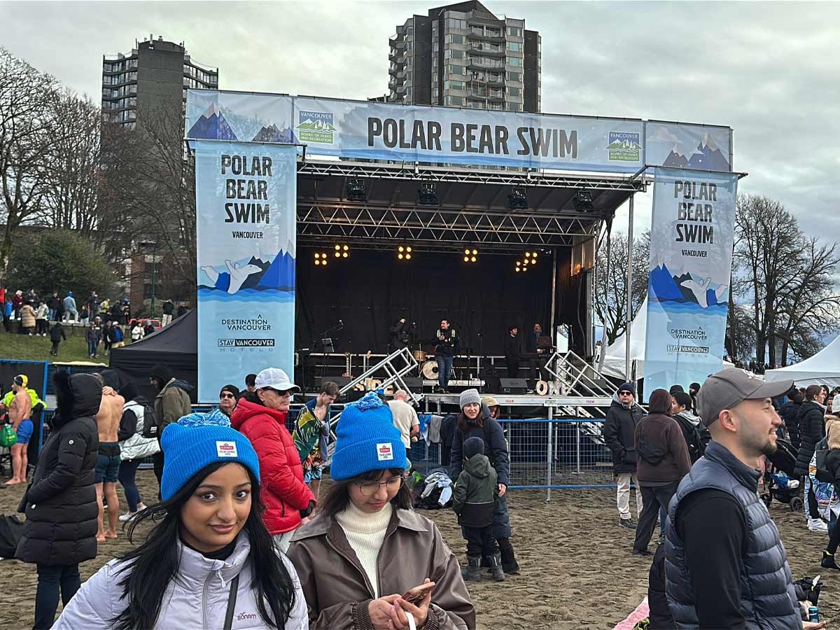 Stage and crowd at English Bay during the Polar Bear Swim Vancouver.