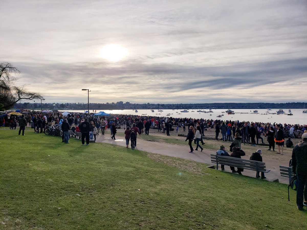 Crowds gather along English Bay Beach for the Polar Bear Swim Vancouver.