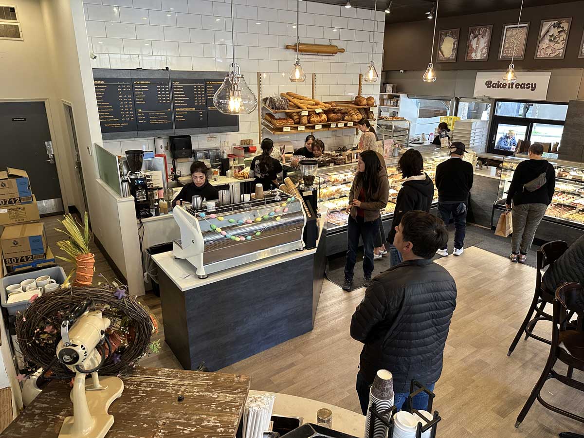 Busy counter and display of fresh pastries at Breka Cafe.