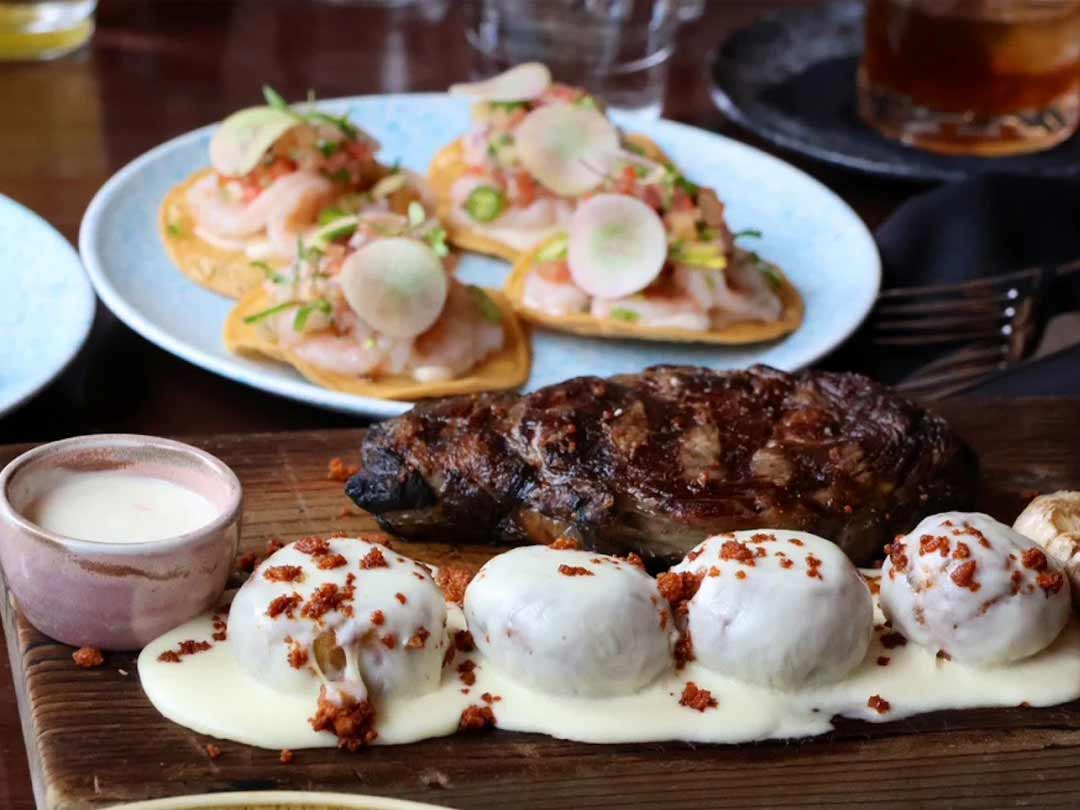 Grilled steak with cheese-covered dumplings and shrimp tostadas.