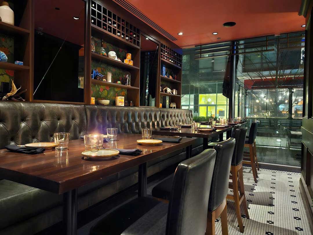 Elegant booth seating with dim lighting and street views.