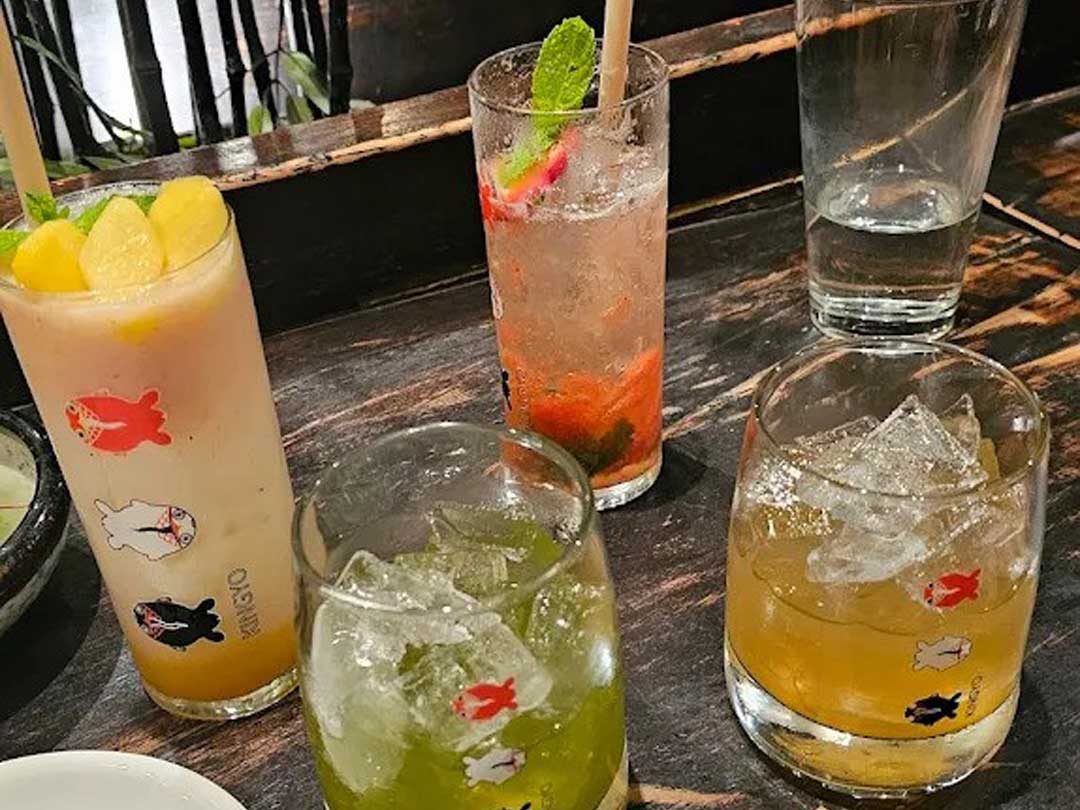 Colorful Japanese drinks in playful fish-themed glasses.