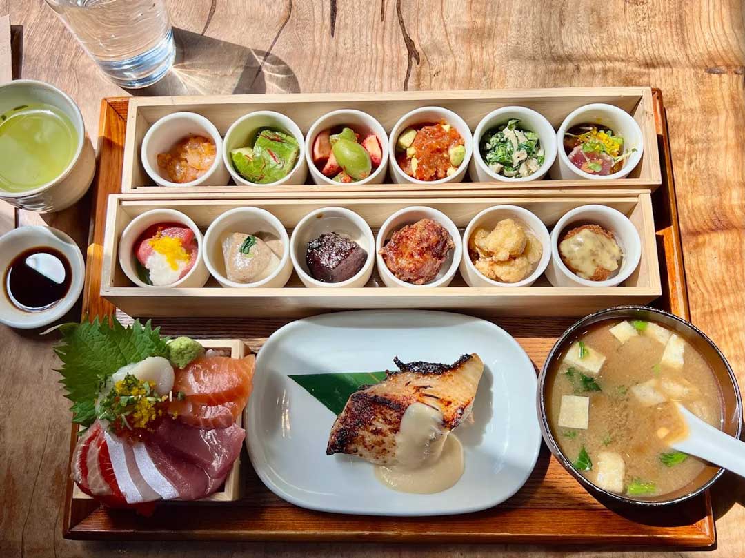 Japanese lunch set with miso soup, sashimi, and 12 sides.