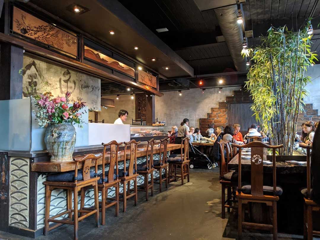 Interior of Kingyo Izakaya with warm lighting and decor.