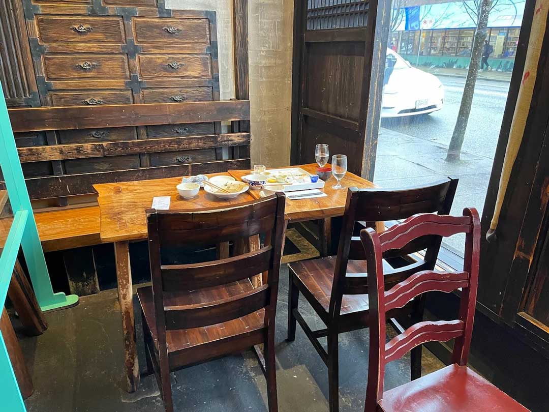 Wooden corner table by the window at Kingyo Izakaya.